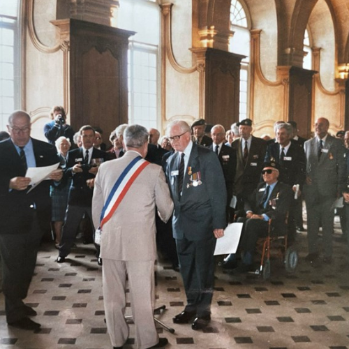Norman Watton receiving a commemorative medal from the Major of Caen
