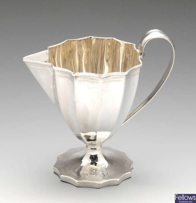 A George III silver pedestal cream jug.