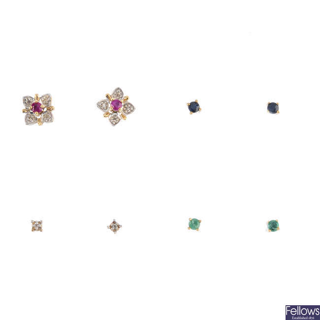 A set of diamond and gem-set interchangeable flower stud earrings.