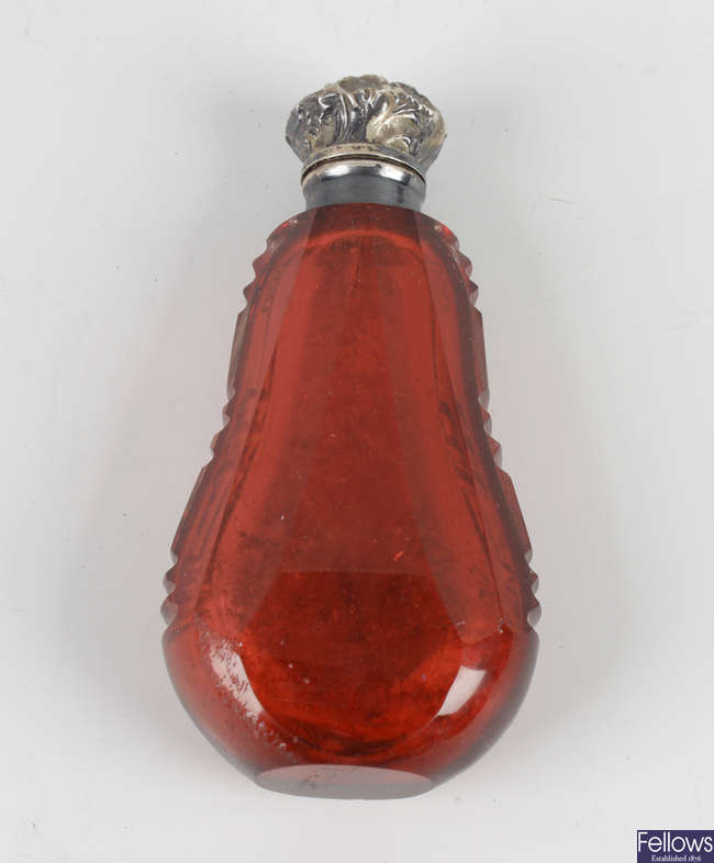 A Victorian cranberry glass scent bottle.