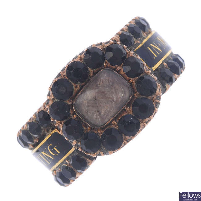 A mid Victorian gold, black garnet, enamel and hair panel ring.