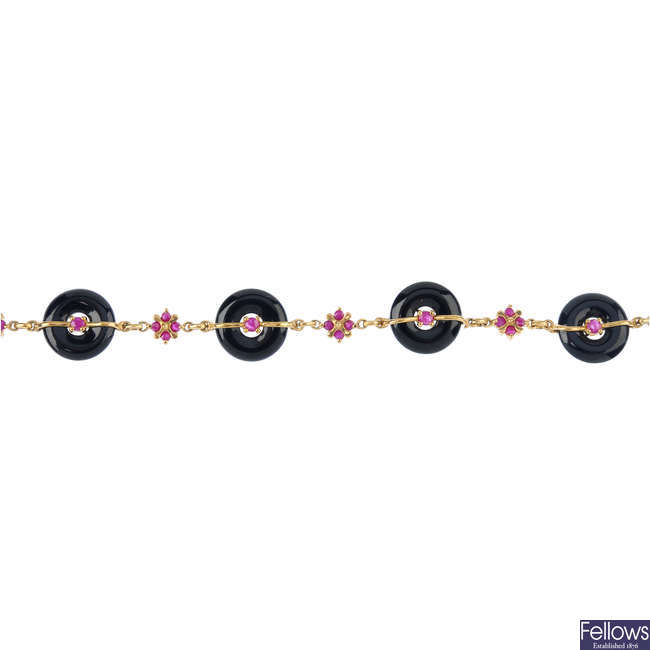 A 9ct gold ruby and onyx bracelet.