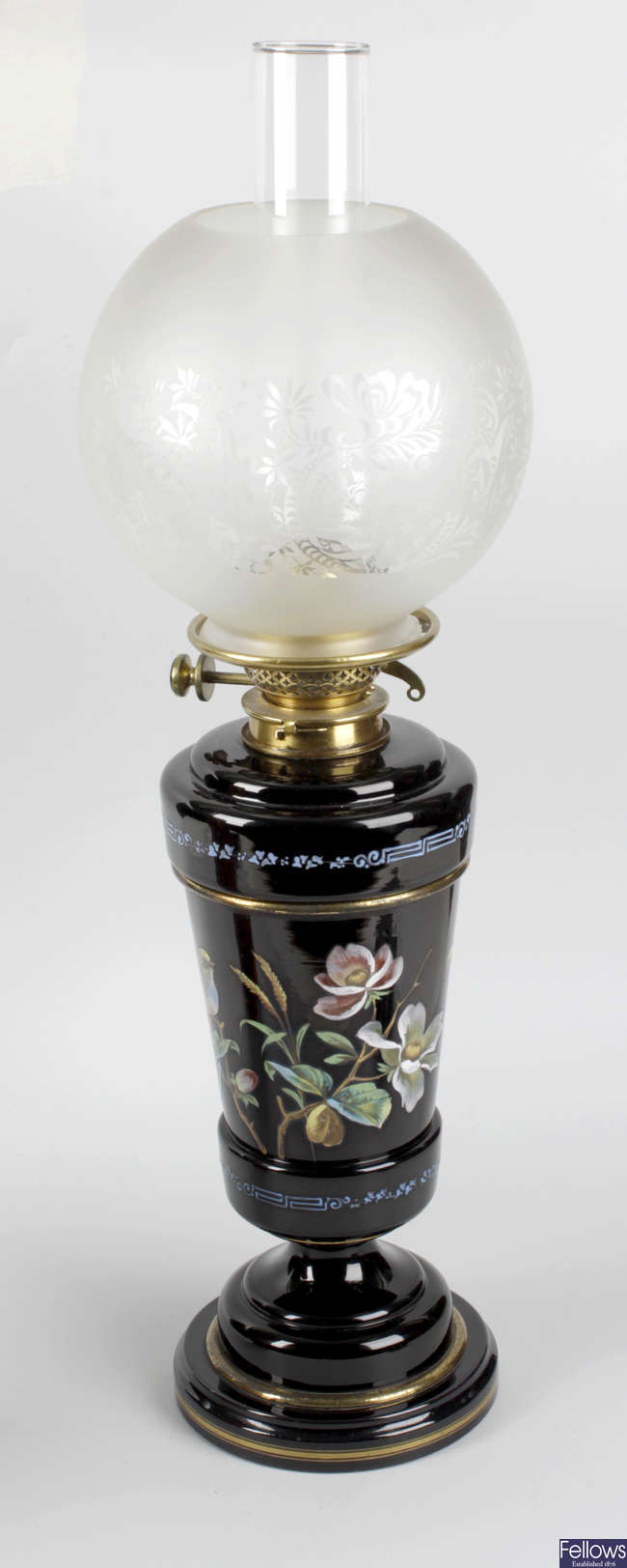 A late 19th century black glass paraffin lamp.