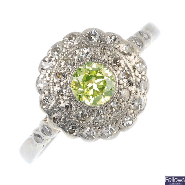 An early 20th century platinum and 18ct gold diamond and 'yellow' diamond cluster ring.