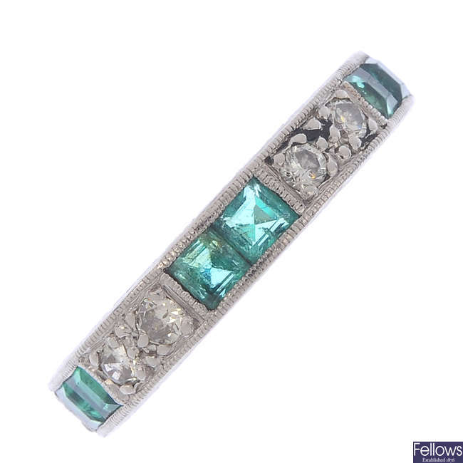 An emerald and diamond eternity ring.