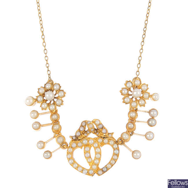 An early 20th century gold split pearl necklace.