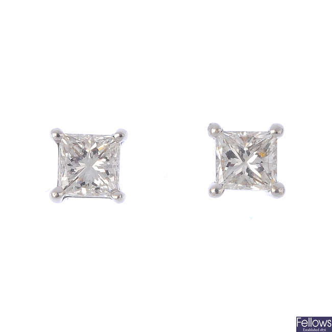 A pair of square-shape diamond single-stone stud earrings.