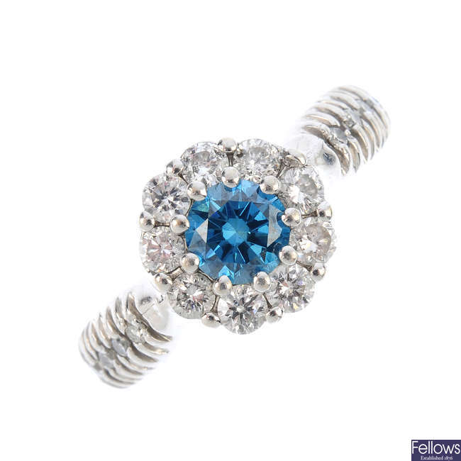 A colour treated 'blue' diamond and diamond cluster ring.