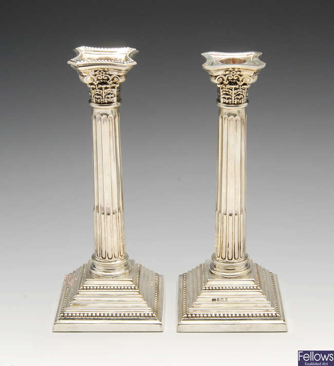 A pair of modern silver mounted Corinthian candlesticks.