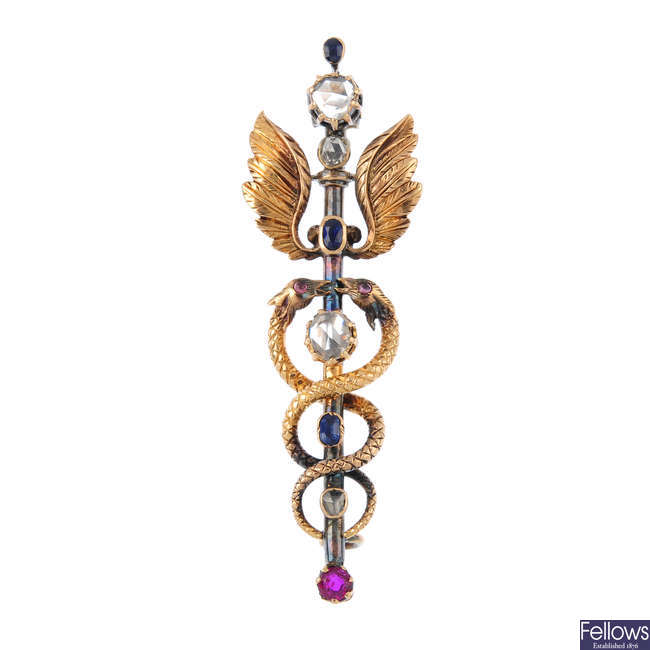 A late Victorian 15ct gold and silver diamond and gem-set caduceus brooch.