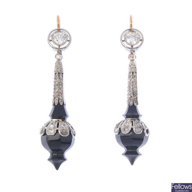 A pair of onyx and diamond earrings.