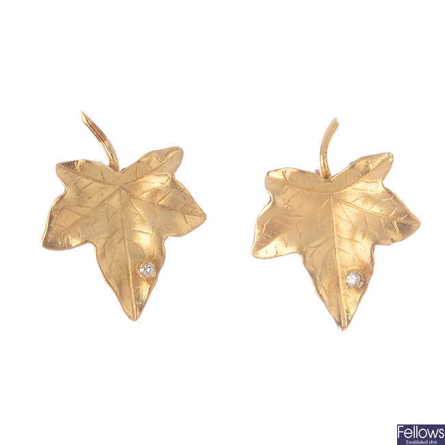 A pair of diamond ivy leaf earrings.
