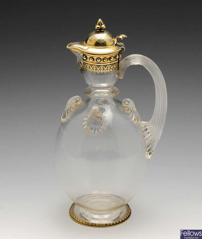 A Victorian silver-gilt mounted glass claret jug.