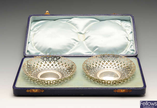 A cased pair of early 20th century silver bonbon dishes of circular form.