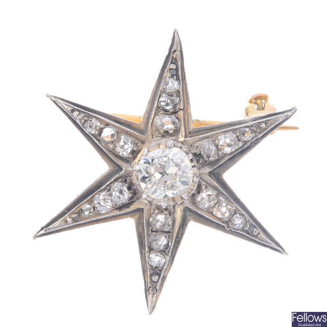 A diamond star brooch.