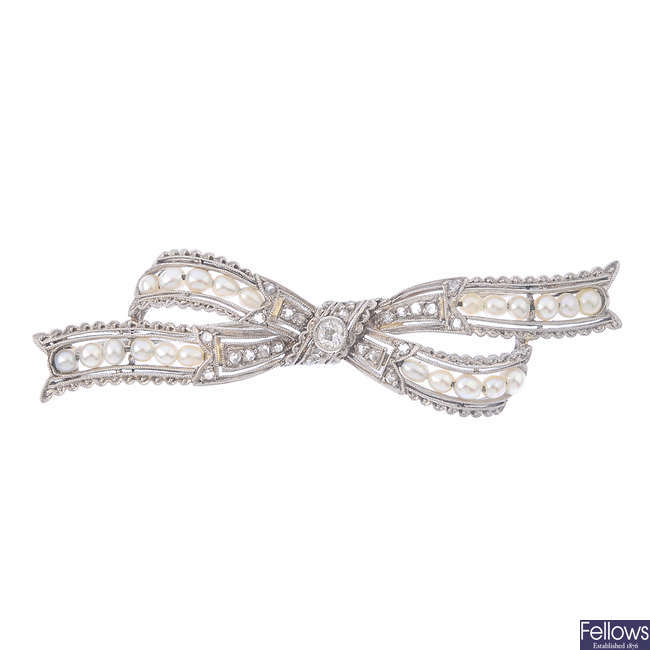 An early 20th century gold, diamond and seed pearl bow brooch.