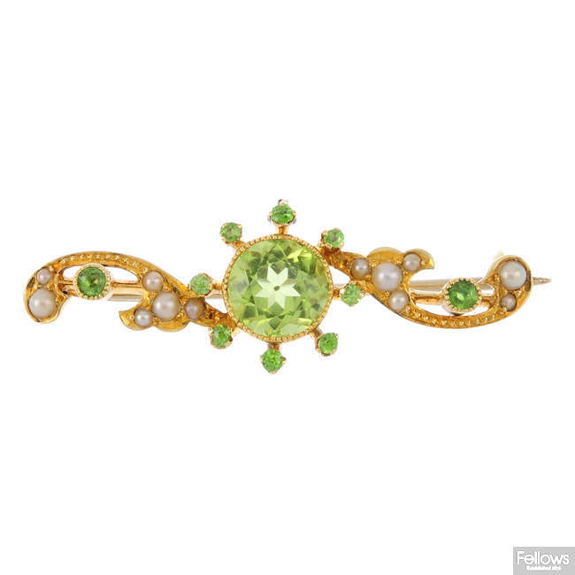 An early 20th century 15ct gold peridot, garnet and split pearl brooch.