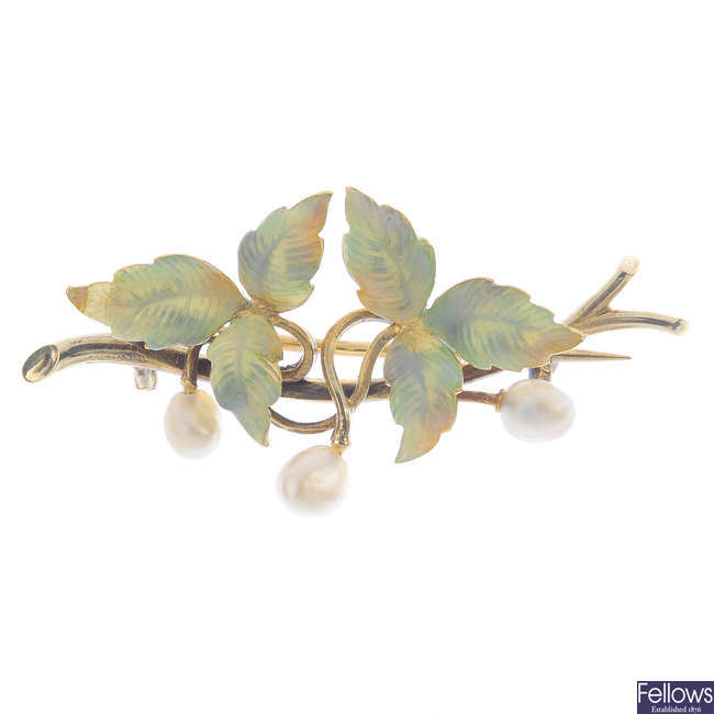An Art Nouveau 14ct gold enamel and pearl flower brooch.