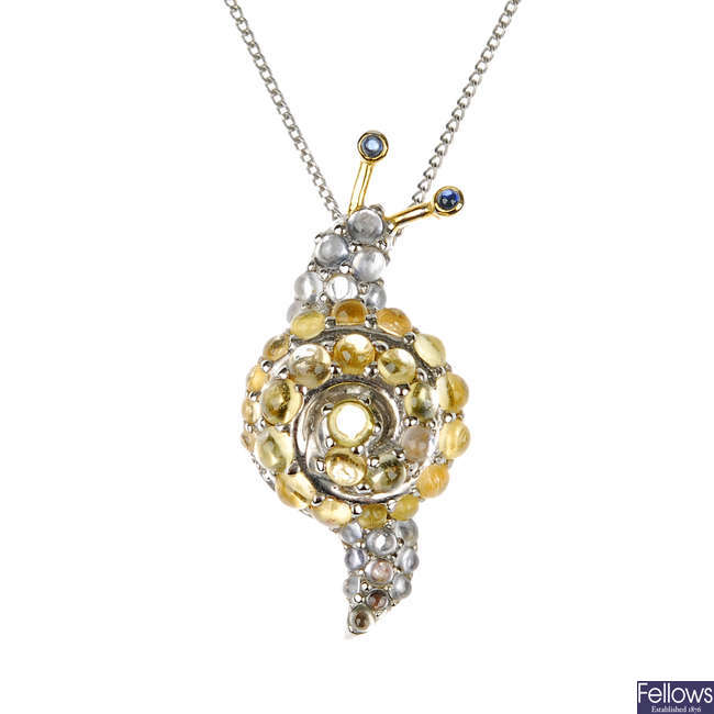 A gem-set snail pendant.