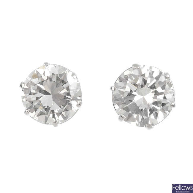 A pair of brilliant-cut diamond single-stone stud earrings.