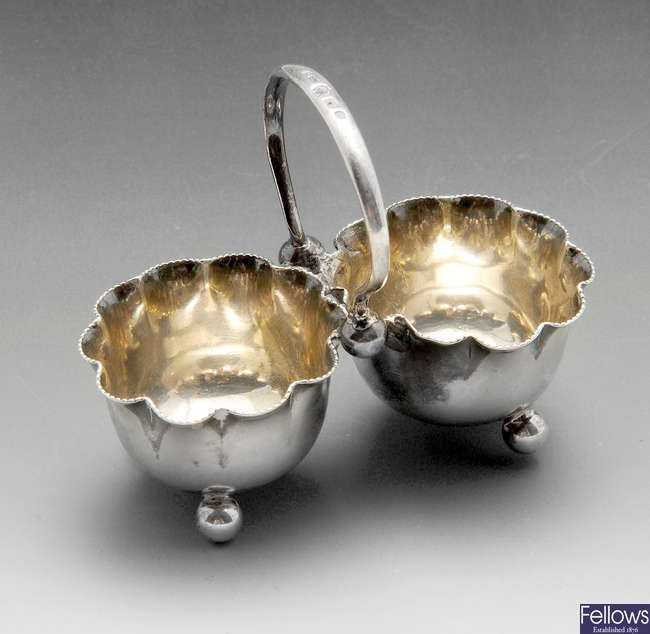 A late Victorian silver cruet, a pair of George V silver pepperettes, etc.
