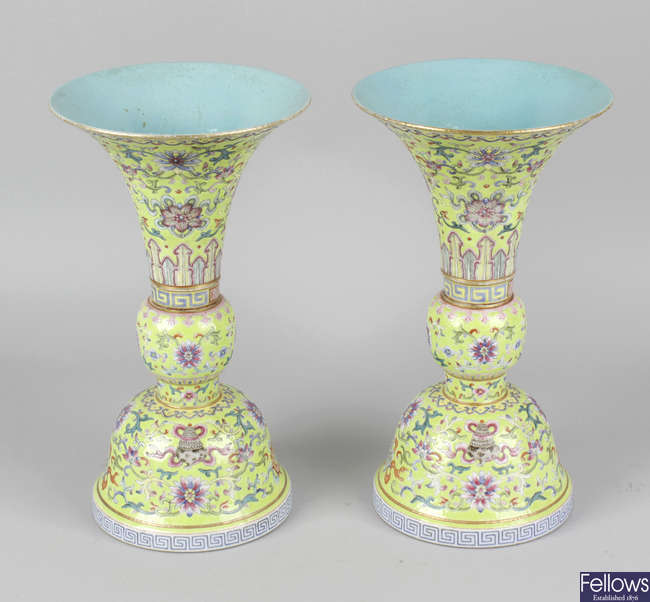 A pair of fine Chinese porcelain famille rose yellow ground vases, with old collector's labels to bases relating to preeminent early 20th century Chinese art and artefacts dealer Ching Tsai Loo.