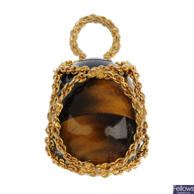 A gold tigers-eye pendant.
