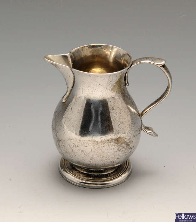 A George II silver sparrow beak cream jug.