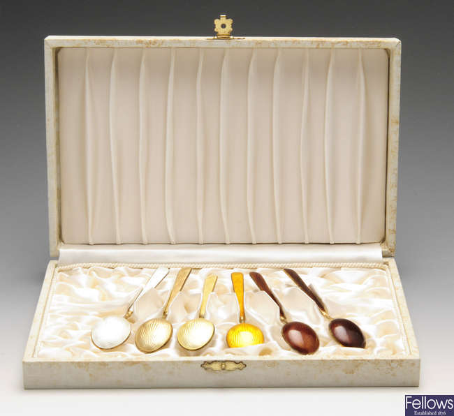 A cased set of six silver-gilt and enamel teaspoons.