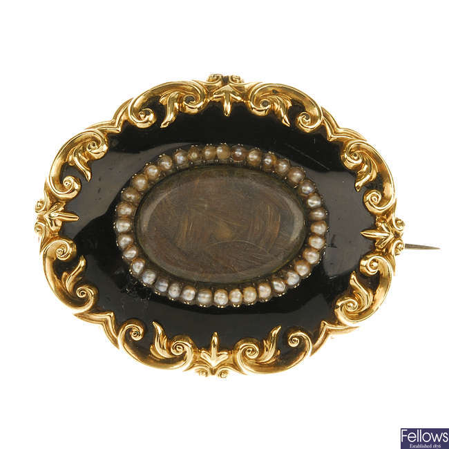 A late Victorian enamel and seed pearl memorial brooch. 