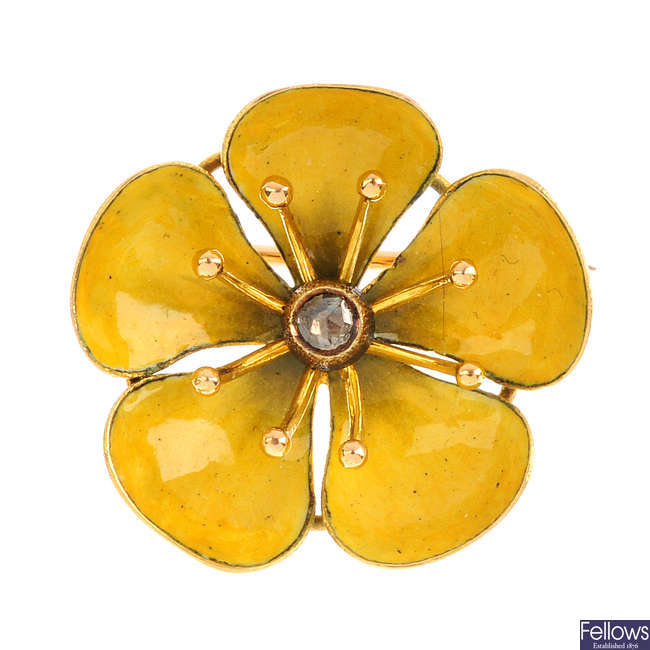 A diamond and enamel floral buttercup brooch.