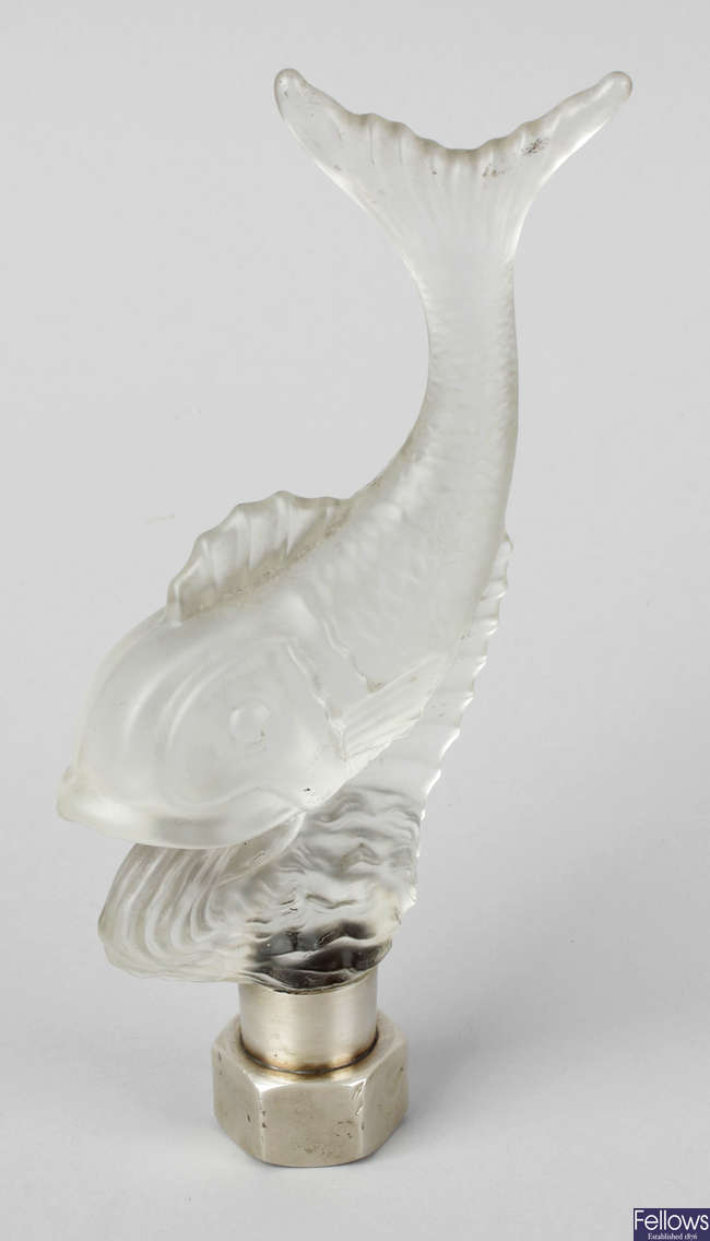 An Art Deco frosted glass ornament modelled as a fish upon a wave.