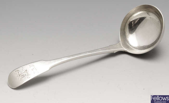 A George III silver sauce ladle and a pair of George III silver sugar tongs. (2).