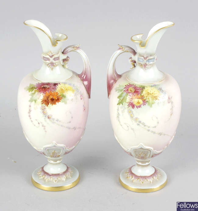 A pair of Royal Worcester ewers.