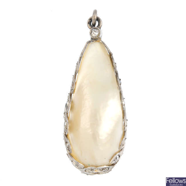A blister pearl and diamond pendant.