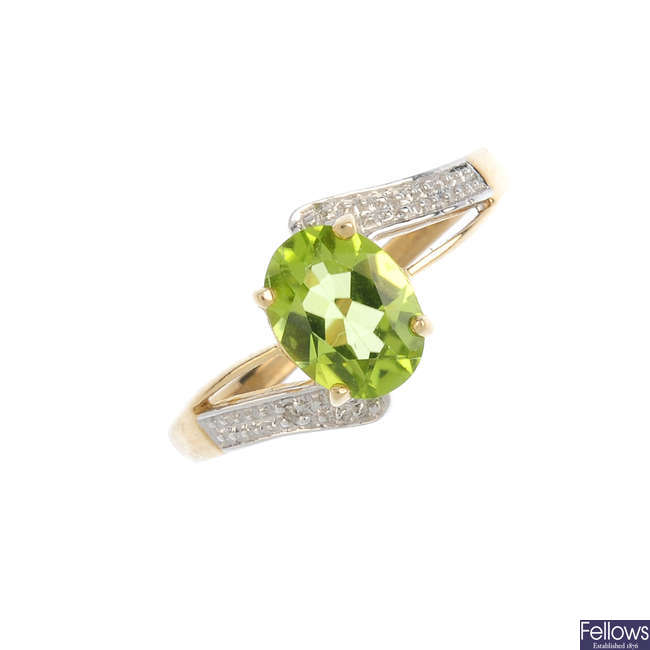 A 9ct gold peridot and diamond cross-over ring.
