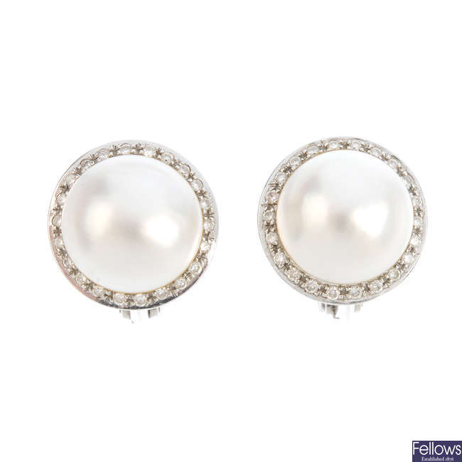 A pair of diamond and mabe pearl earrings.