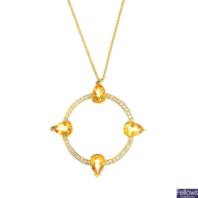 An 18ct gold citrine and diamond compass pendant.