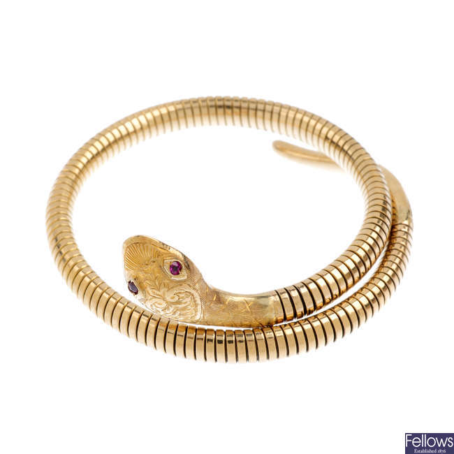 A 1950s 9ct gold gem-set flexible snake bangle.