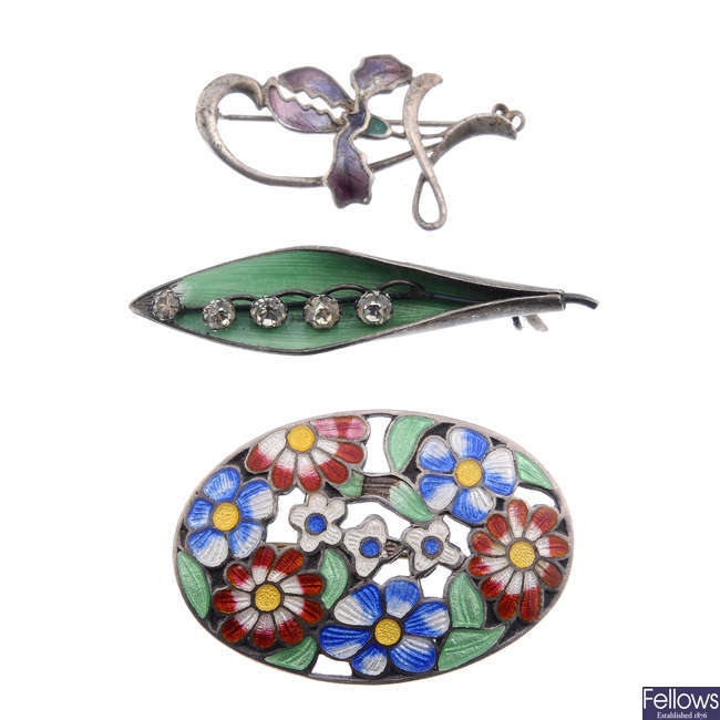 A selection of enamel brooches. 