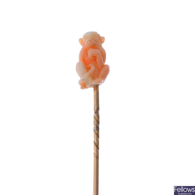 An early 20th century coral monkey stickpin.