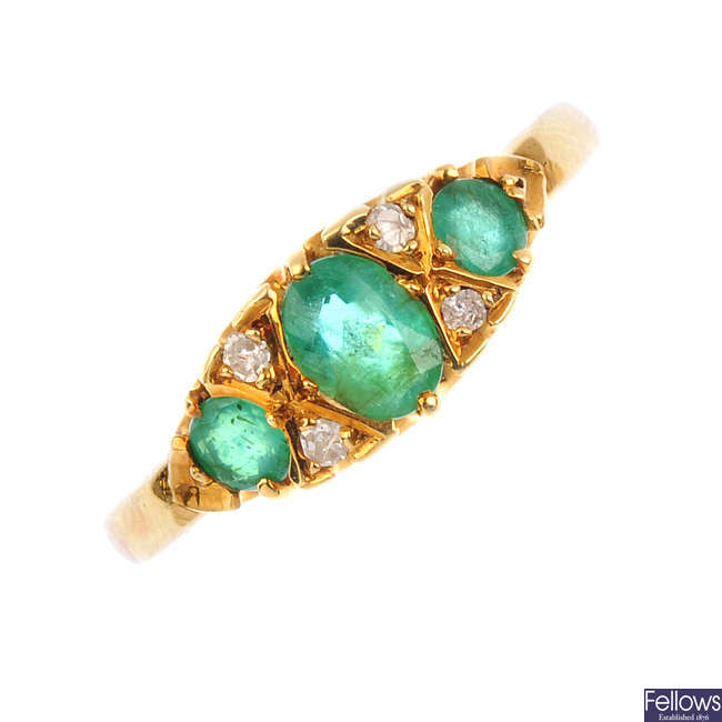 An 18ct gold emerald and diamond dress ring.