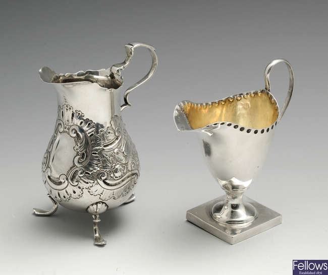 A Victorian silver cream jug & an Edwardian example. (2).