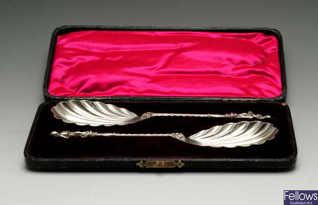 A pair of late Victorian cased silver server spoons.