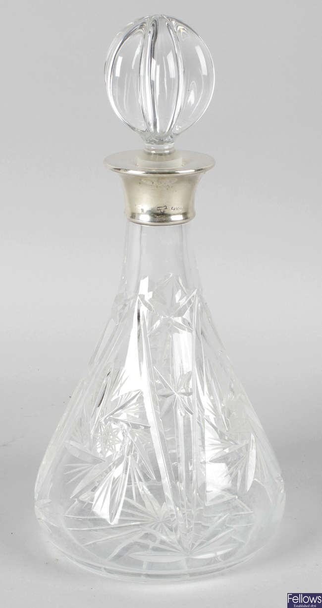A cut glass decanter and stopper.