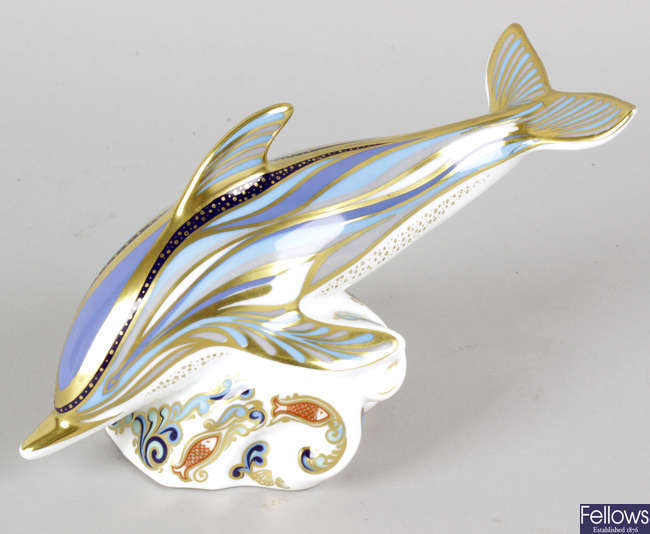 A Royal Crown Derby porcelain paperweight modelled as a dolphin.