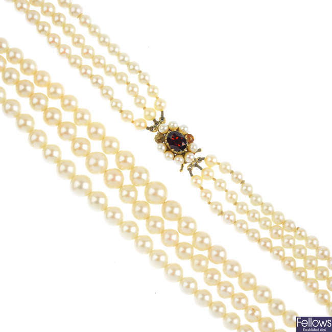 A cultured pearl three-row necklace, with garnet and cultured pearl clasp.