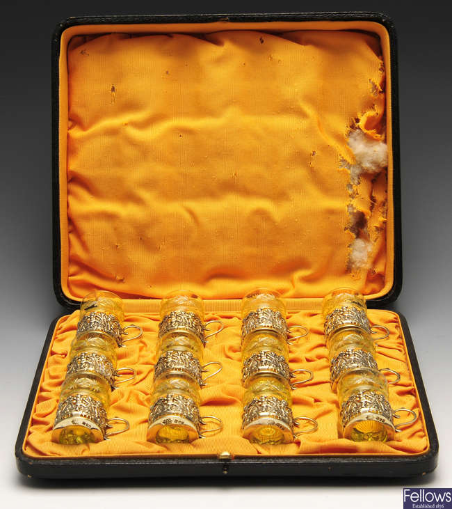 An early twentieth century set of twelve silver-gilt mounted tot cup glasses.