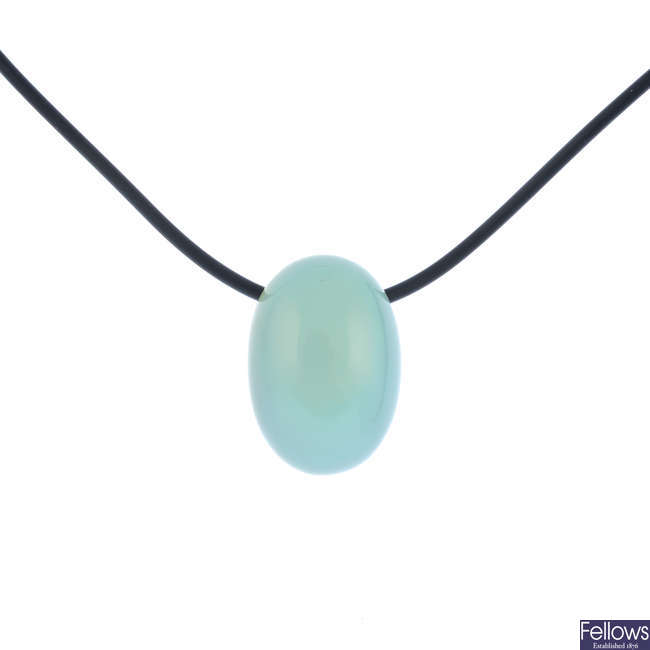 A chalcedony pendant, on cord.