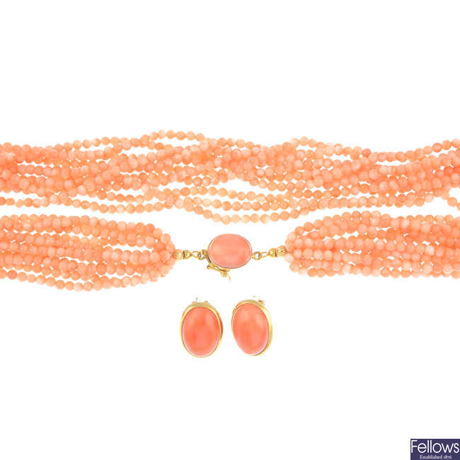A coral multi-strand necklace and a pair of matching earrings.